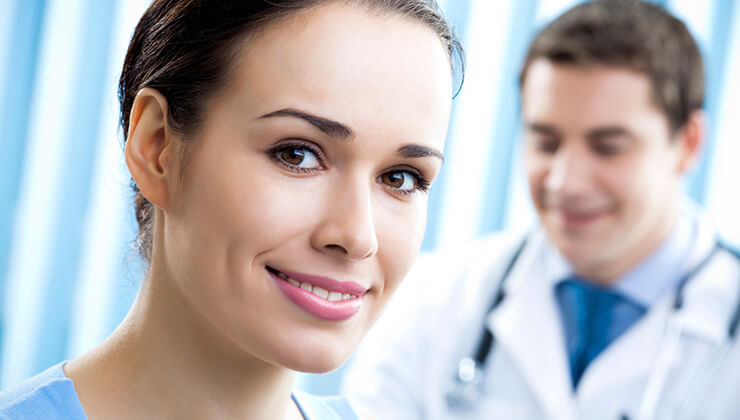 Happy female patient and doctor at office